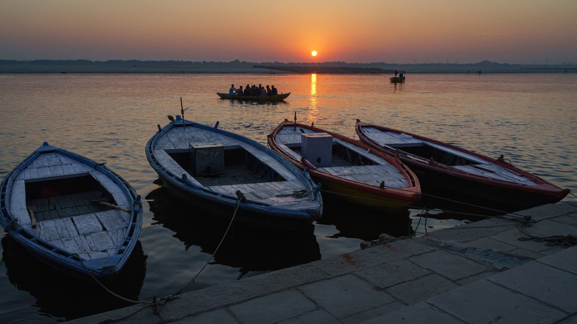 Boats on the Ganges at sunrise below the ghats of Varanasi